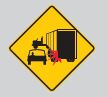 keep away from large vehicles such as trucks and buses in a roundabout.