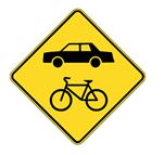 Cyclists and motorists are both travelling on a roadway recognized as a bikeway